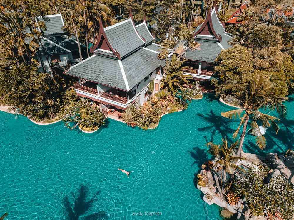 Aerial view of the lagoon pool and tropical resort buildings at Thavorn Beach Village